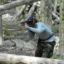 Player aiming through wooden cover deep in the forest